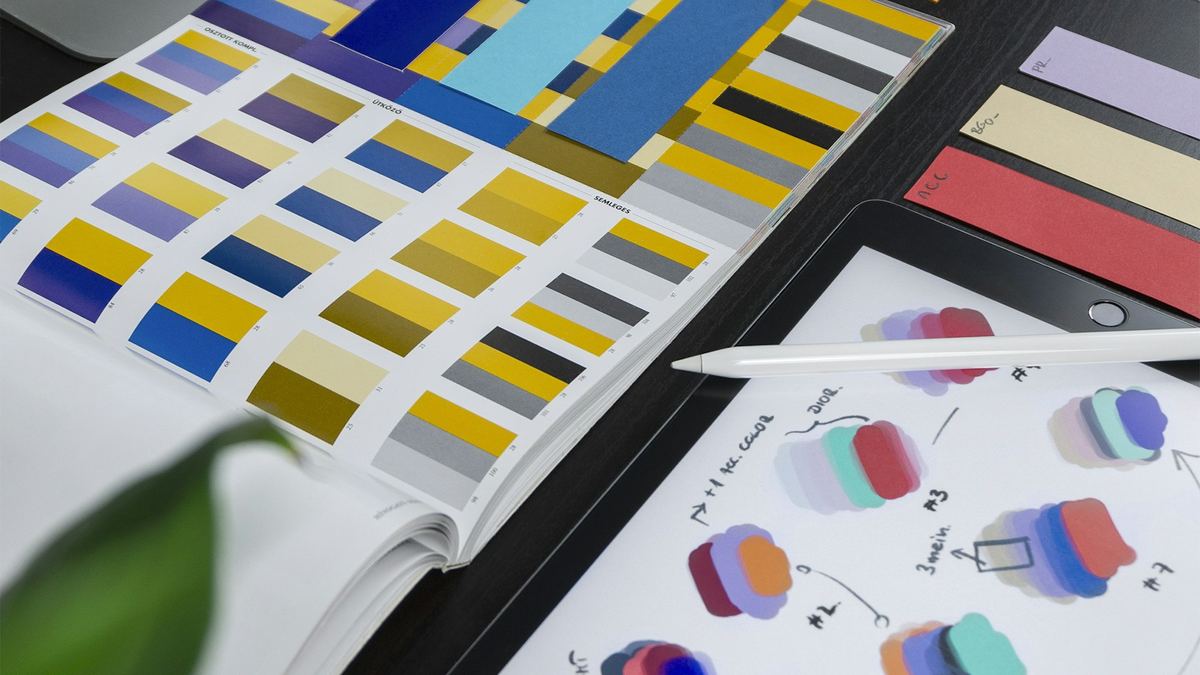Colour swatches and brand guidelines on a desk