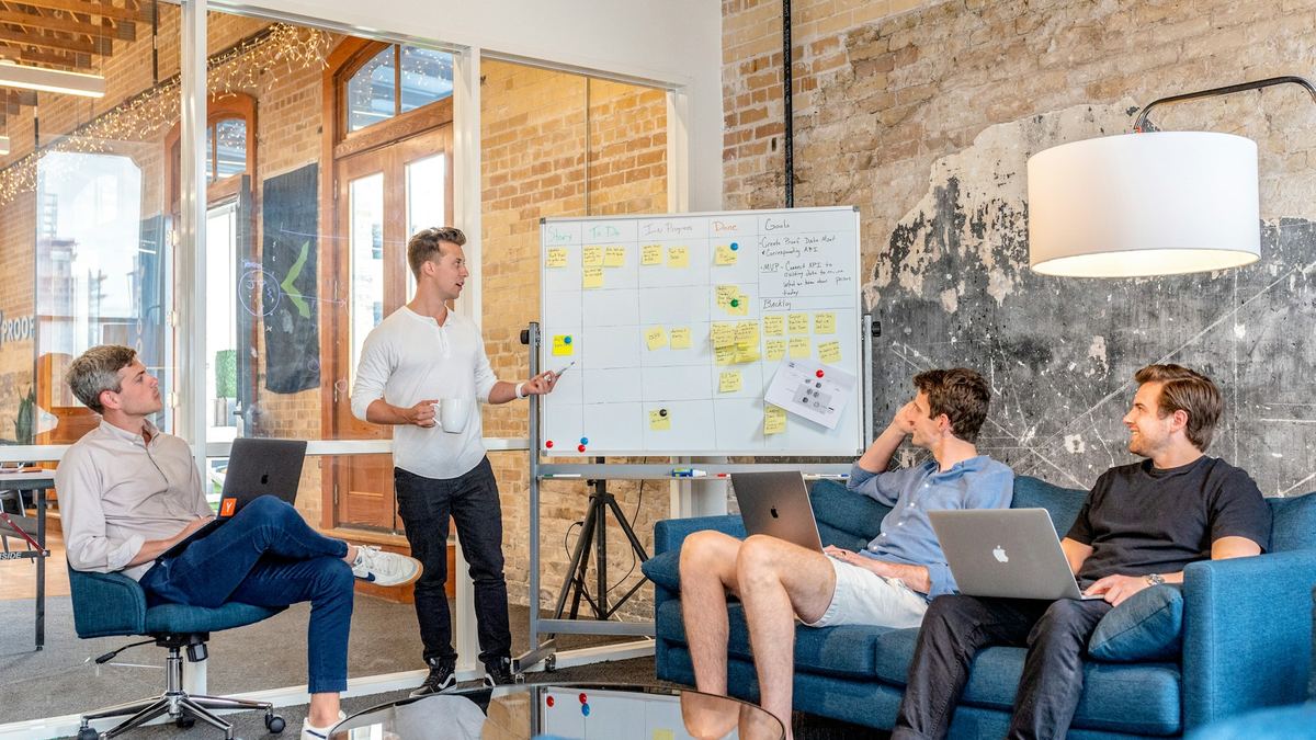 Team collaborating at a whiteboard in a modern office