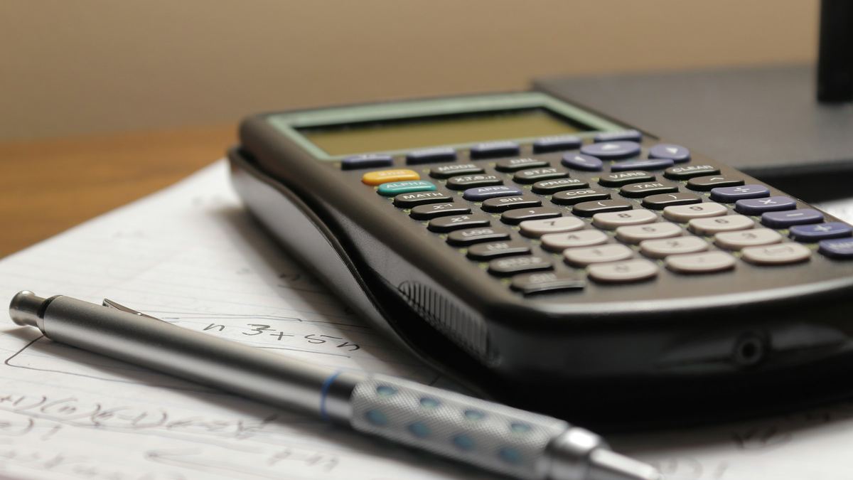 Calculator and pen on financial documents