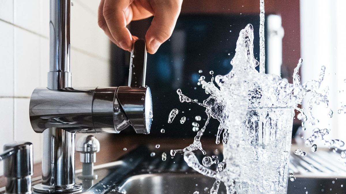 Plumber fixing a kitchen tap